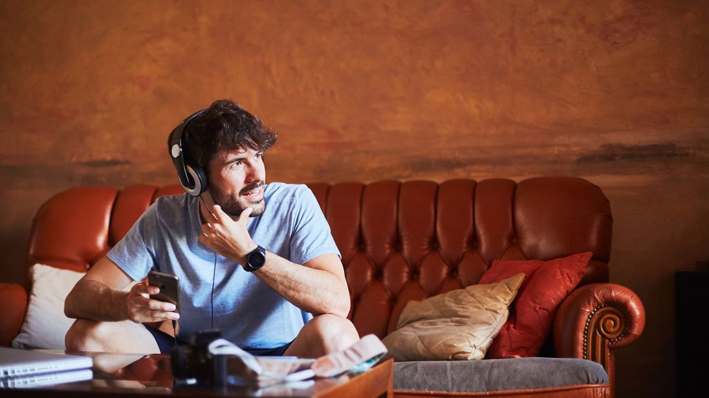 mand snakker i telefon i sofa